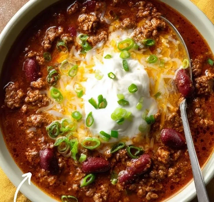 Bowl of award-winning championship chili garnished with herbs