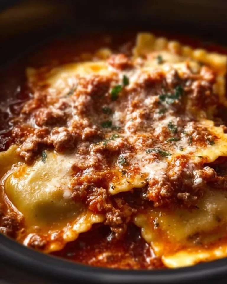 A delicious crockpot ravioli lasagna with layers of cheese and marinara sauce.